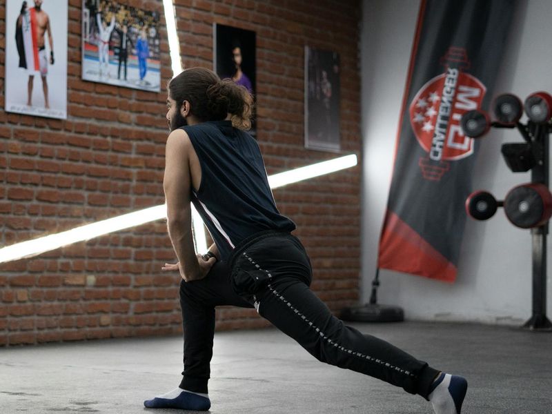 Man in a dynamic pose during a workout session.